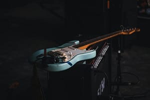 teal and brown electric guitar